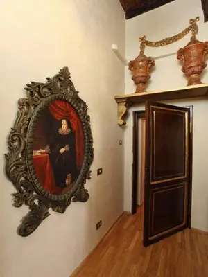 a mirror on a wall with a painting of a woman at Antica Dimora dell'Orso in Rome