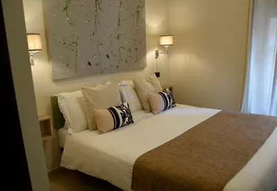 a bedroom with a large white bed with pillows at Holiday a San Pietro in Rome