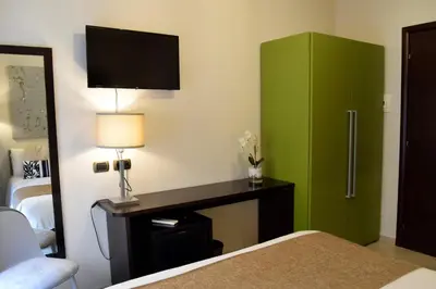 a bedroom with a green cabinet and a desk at Holiday a San Pietro in Rome