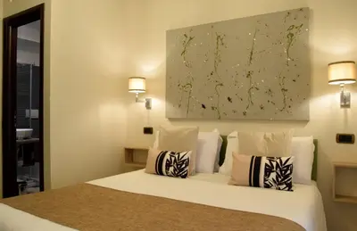 a bedroom with a white bed with two pillows at Holiday a San Pietro in Rome