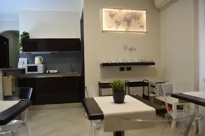 a dining room with a table and chairs and a kitchen at Holiday a San Pietro in Rome