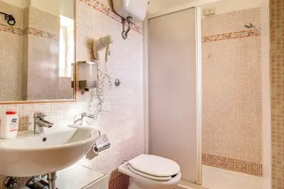 a bathroom with a sink and a toilet and a shower at Giovy in Rome