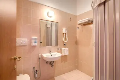 a bathroom with a sink and a toilet and a mirror at Giovy in Rome