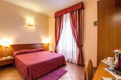 a hotel room with a bed and a window at Giovy in Rome