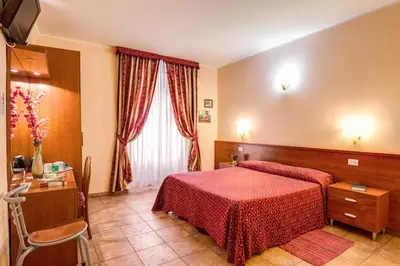 a hotel room with a red bed and a window at Giovy in Rome