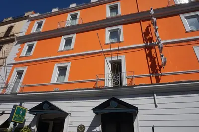 an orange and white building with a lot of windows at Hotel Laurentia in Rome