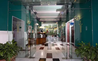 a hallway of a building with green walls at Ateneo Garden Palace in Rome