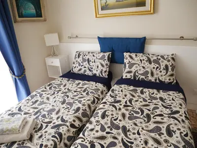 a bedroom with two beds next to a window at Nori Guest House in Rome