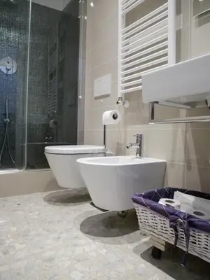 a bathroom with a tub and a toilet and a sink at Nori Guest House in Rome