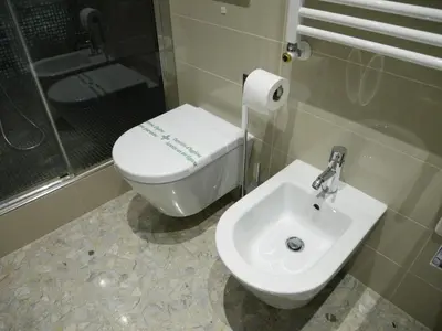 a bathroom with a toilet and a sink at Nori Guest House in Rome