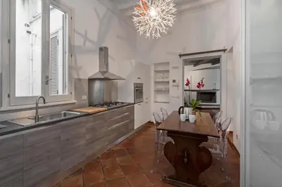 a kitchen with a table and a sink and a stove at Antique-Modern Flat by Navona Square in Rome