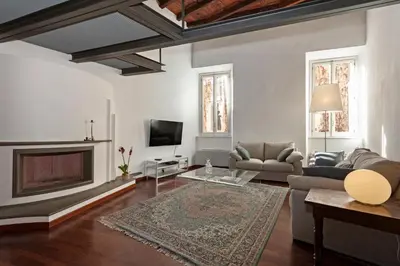 a living room with a couch and a fireplace at Antique-Modern Flat by Navona Square in Rome