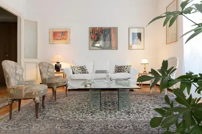 a living room with a couch and two chairs at Flower's Market Apartment - Charme Holidays in Rome