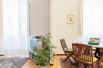 a dining room with a table and a fish tank at Flower's Market Apartment - Charme Holidays in Rome