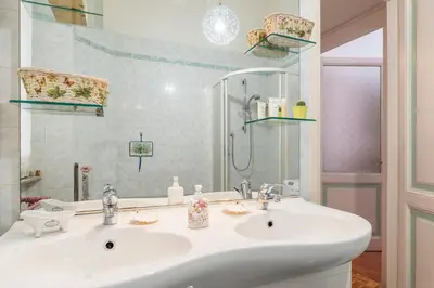 a bathroom with a white sink and a mirror at Flower's Market Apartment - Charme Holidays in Rome