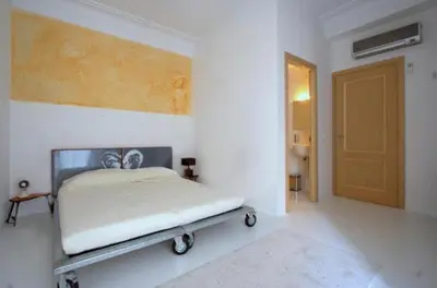 a white room with a bed and a door at A Casa Di Penelope in Rome