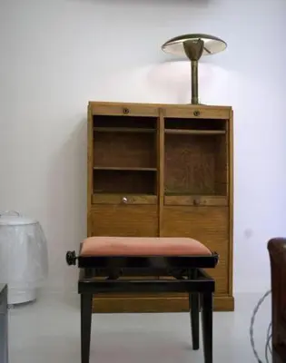 a table with a lamp on top of a wooden cabinet at A Casa Di Penelope in Rome