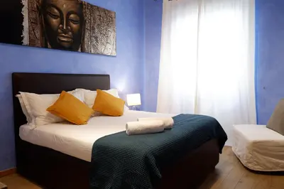 a bedroom with a king sized bed with yellow pillows at The Blue Strawberry House in San Giovanni Roma in Rome