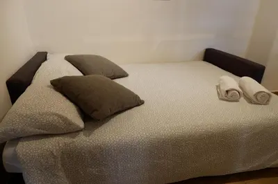 a bed with two slippers on top of it at The Blue Strawberry House in San Giovanni Roma in Rome