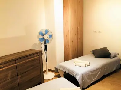 a bedroom with a fan next to a bed at The Blue Strawberry House in San Giovanni Roma in Rome