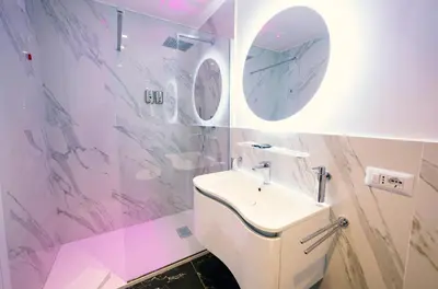 a bathroom with a white toilet and a sink at San Pietro Grand Suite in Rome