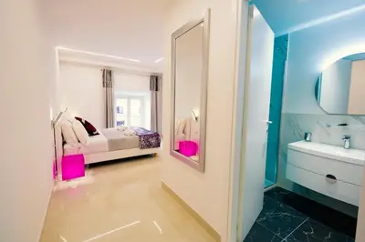 a bathroom with a bed and a sink and a mirror at San Pietro Grand Suite in Rome