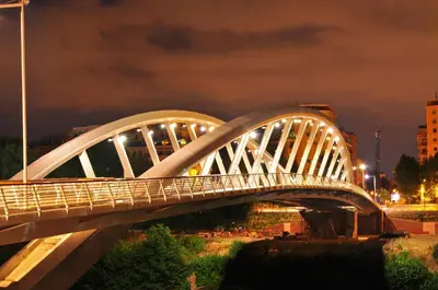 a white bridge over a river at night at Guest House Vignola in Rome