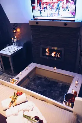 a room with a fireplace and a tv above it at Roma d'Amore in Rome