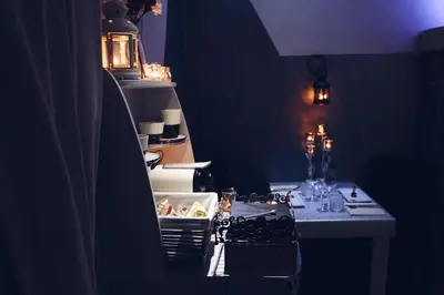 a kitchen with a stove and a table in a room at Roma d'Amore in Rome