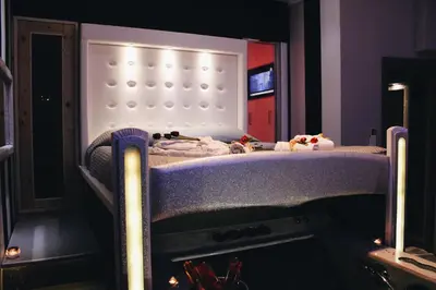 a bed in a room with a fireplace at Roma d'Amore in Rome