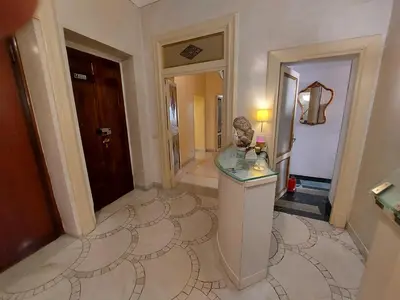 a hallway of a hotel with aoyer with a mirror at Residenza Al Corso Suites in Rome