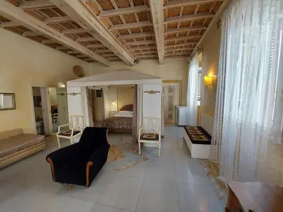 a large living room with a bed and a couch at Residenza Al Corso Suites in Rome