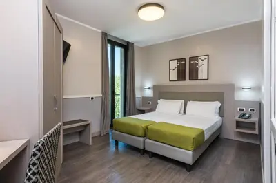 a hotel room with a bed and a window at Noba Hotel e Residenze in Rome