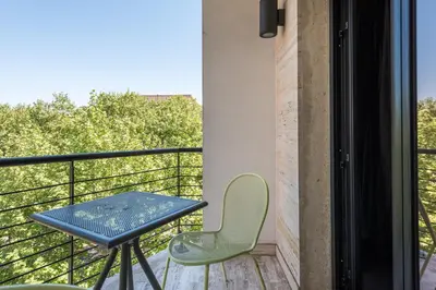a table and chairs on a balcony with a view at Noba Hotel e Residenze in Rome