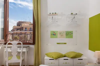 a room with a window and a table and a chair at Boutique Domus Trastevere Vascellari in Rome