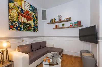a living room with a couch and a flat screen tv at Boutique Domus Trastevere Vascellari in Rome