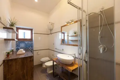 a bathroom with a sink and a toilet and a shower at Boutique Domus Trastevere Vascellari in Rome