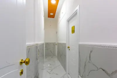 a white bathroom with a shower and a door at Miss Suite in Rome