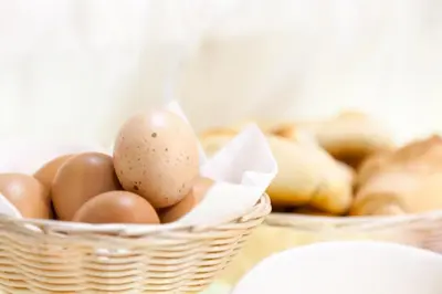 two baskets of eggs and bread on a table at Miss Suite in Rome