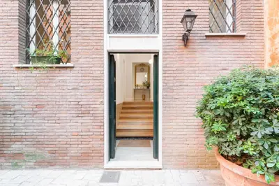 a door leading into a brick building with a staircase at Lovatelli Home al Campidoglio in Rome