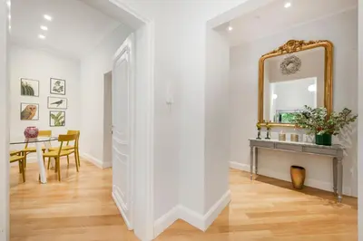 a hallway with a table and a mirror at Lovatelli Home al Campidoglio in Rome
