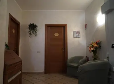 a living room with a door and a couch at Le Quattro Meraviglie in Rome