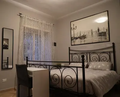 a bedroom with a black bed and a table and a window at Le Quattro Meraviglie in Rome