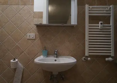 a bathroom with a sink and a mirror at Le Quattro Meraviglie in Rome