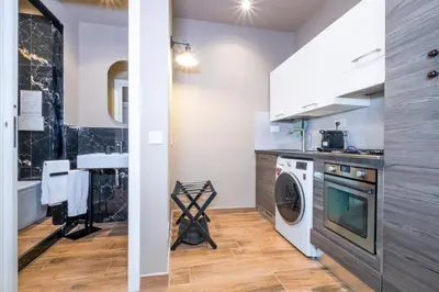 a laundry room with a washer and dryer at HT Residence Maximus in Rome