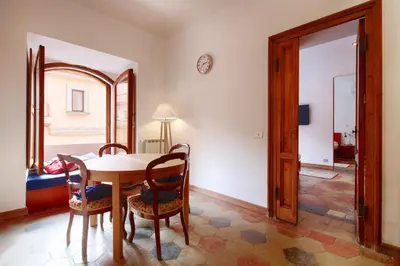 a dining room with a table and chairs in a room at HT Residence Maximus in Rome