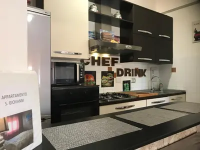 a kitchen with a microwave and a stove top oven at Appartamento S.Giovanni in Rome