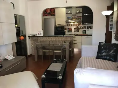 a living room with a table and a kitchen at Appartamento S.Giovanni in Rome