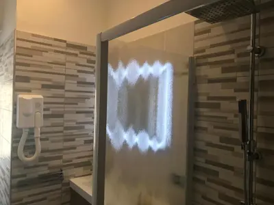 a shower with a glass door in a bathroom at Appartamento S.Giovanni in Rome