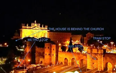 a large building with a sign on it at night at Appartamento S.Giovanni in Rome